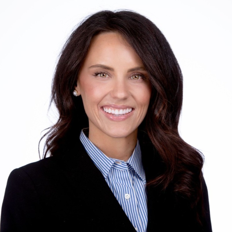 Casey Heck, SVP of HR at Traliant seen with a bright smile on her face